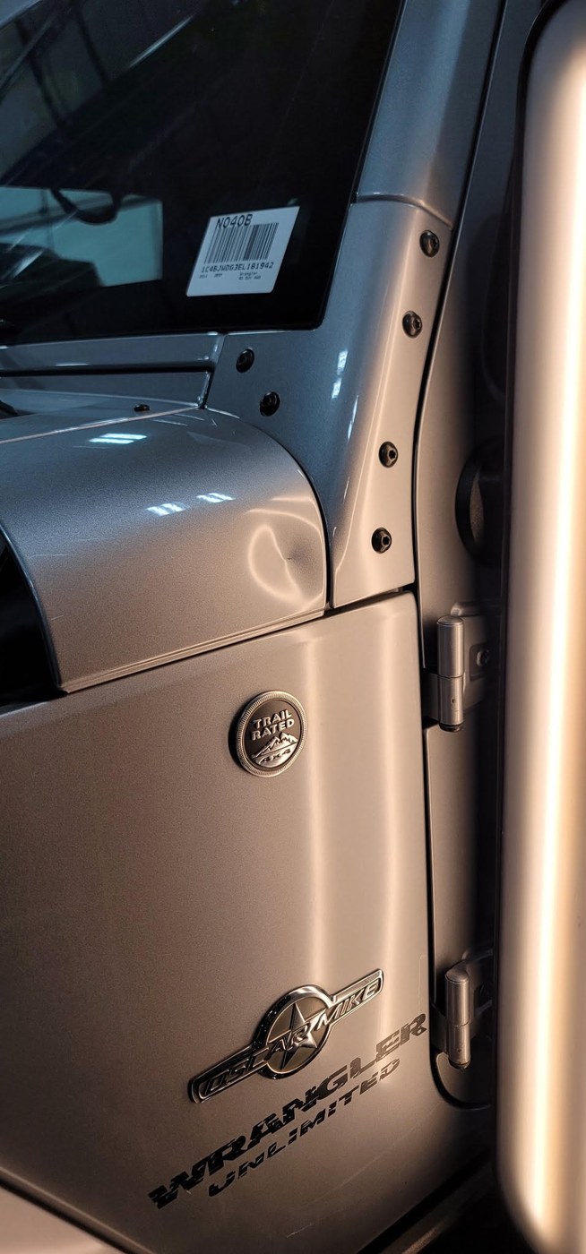 Jeep Wrangler door panel with dent before Apex paintless dent repair
